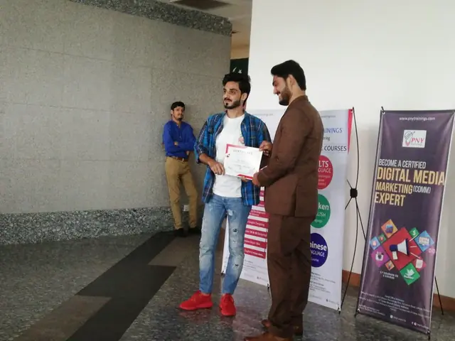 Usman Saeed awarding a digital media marketing certificate to a student at PNY Trainings